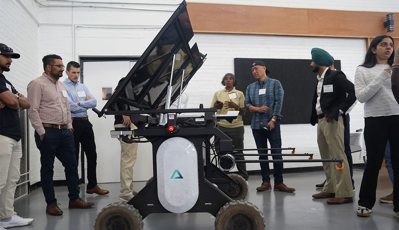 Aigen co-founder Kenny Lee (third from right) demonstrates the Aigen Element, an autonomous weeding system for farms, at last week’s Integrative Precision Agriculture Conference. Lee was one of eight UGA Grand Farm partners to present at the conference. (Photo by David Mitchell)