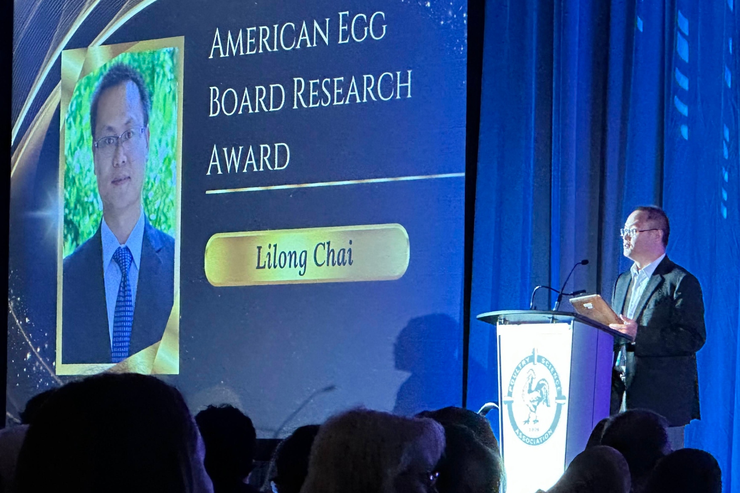 Dr. Lilong Chai accepting his award at the Poultry Science Association annual meeting in 2025.