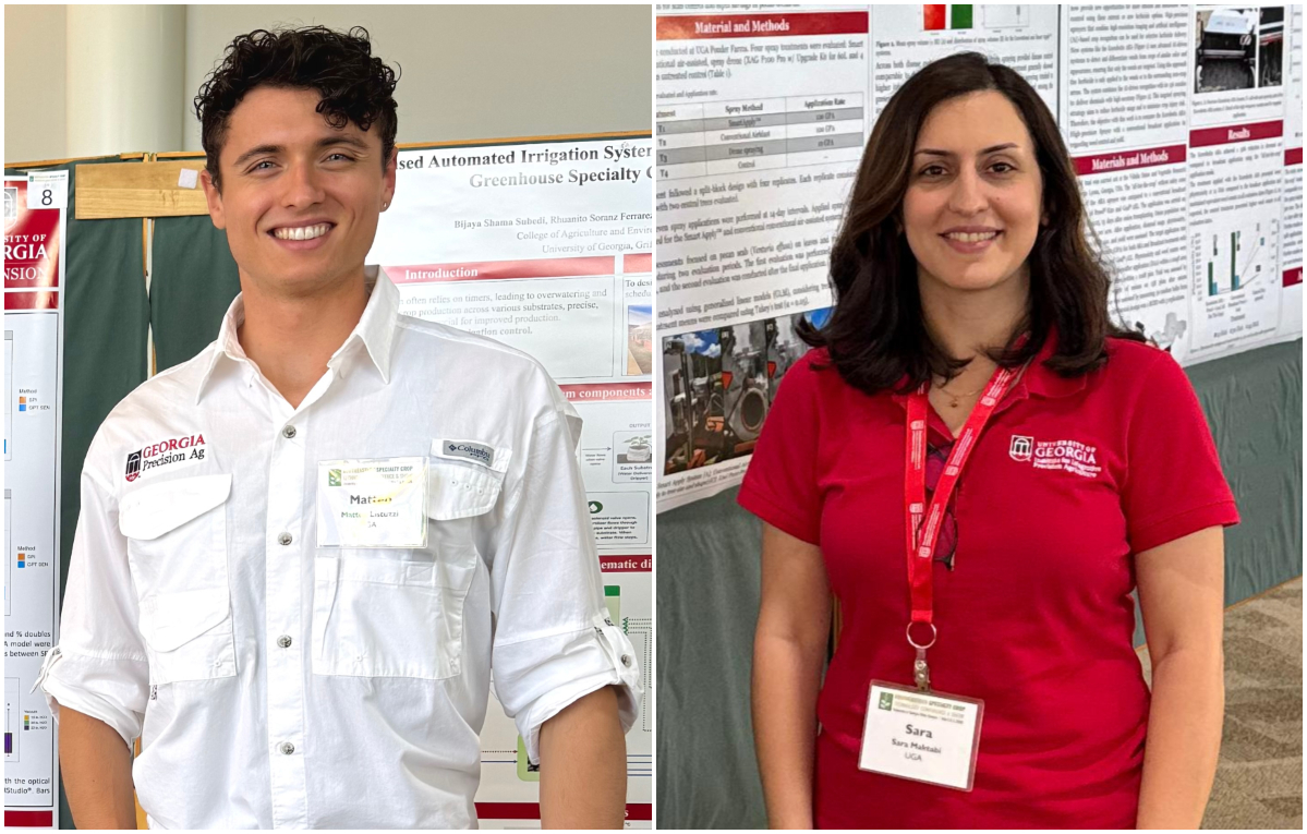 Two people stand in front of research posters at an event, wearing university name tags and shirts with university logos.